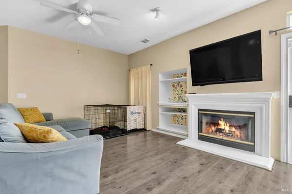 a living room with furniture a flat screen tv and a fireplace