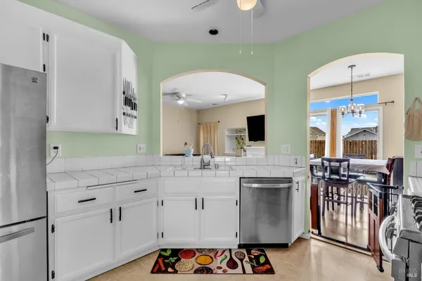 a kitchen with stainless steel appliances a sink stove and cabinets