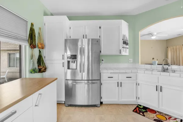 a kitchen with appliances a sink and cabinets