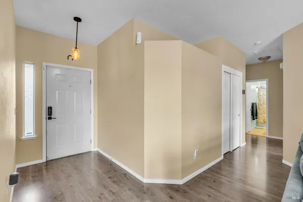 a view of a hallway with wooden floor