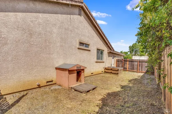 a backyard of a house with barbeque oven
