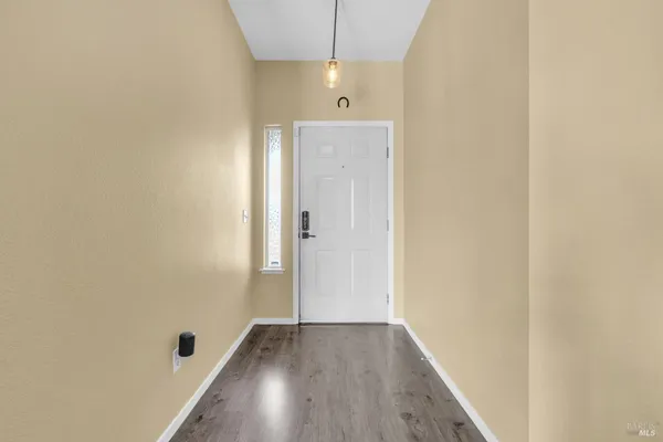 a view of a hallway with wooden floor