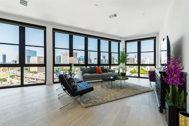 a living room with furniture and a floor to ceiling window or wooden floor