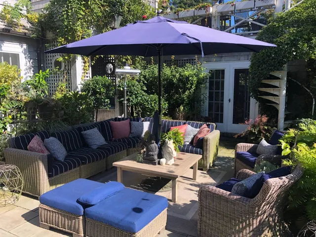 a view of a backyard with plants and outdoor seating