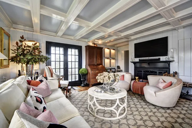 a dining room with furniture a chandelier and wooden floor