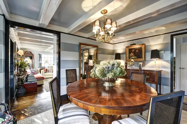 a kitchen with stainless steel appliances kitchen island granite countertop a stove a sink a dining table and chairs