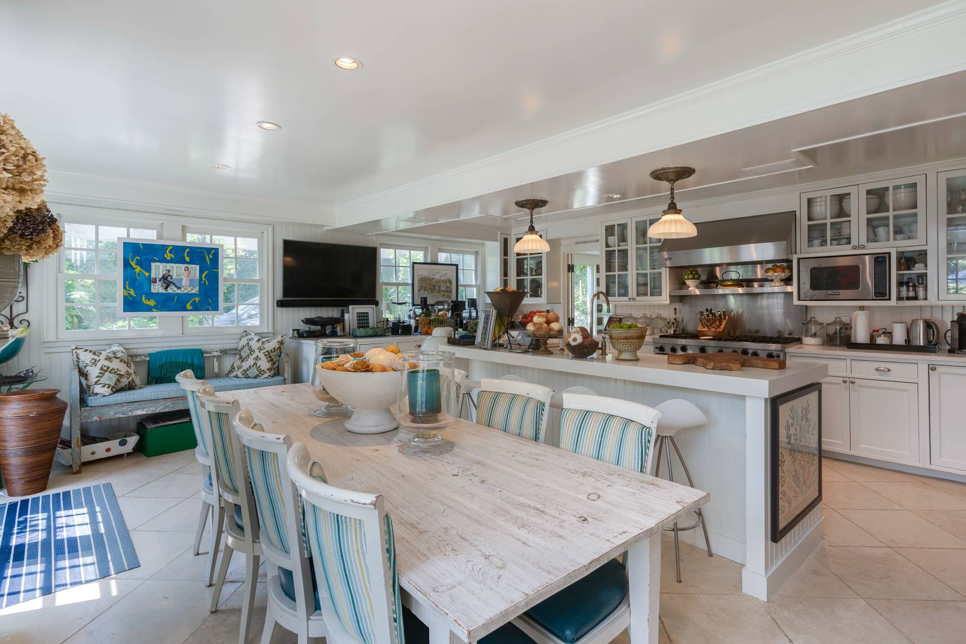 12 Huntington Lane Water Mill, NY 11976 - Photo 25 of 50 a dining room with stainless steel appliances granite countertop a table chairs and a refrigerator