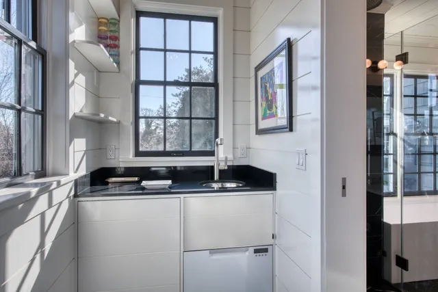 a bathroom with a granite countertop sink a toilet and shower