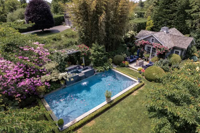 a view of a house with a backyard and sitting area