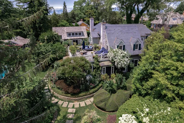a view of a house with a backyard and garden