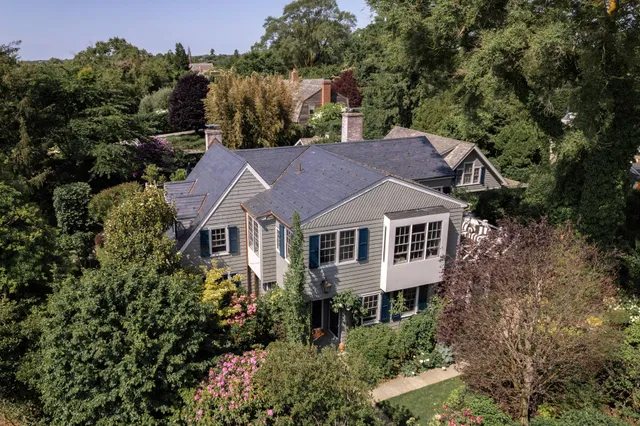 an aerial view of a house with a yard and plants