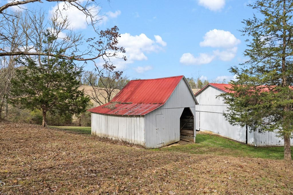 933 Millican Grove Road Sevierville, TN 37876 - Photo 21 of 54 a view of a house with a yard and a large tree