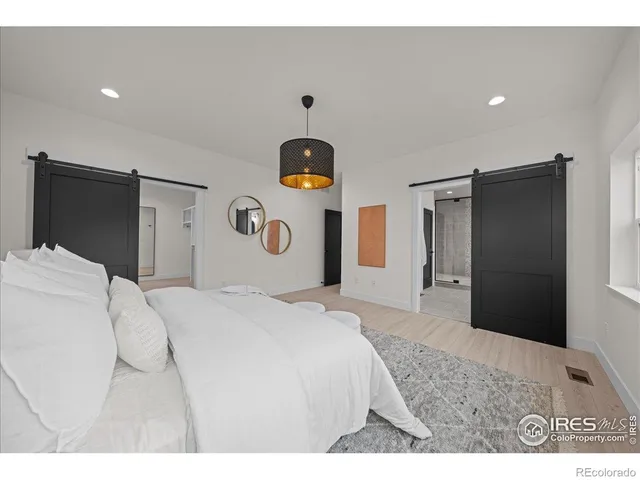 a bedroom with a bed and a refrigerator