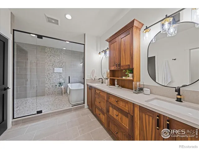 a bathroom with a double vanity sink mirror and shower