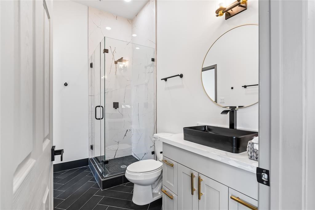 3620 Lehall Street Houston, TX 77021 - Photo 11 of 32 a bathroom with a toilet sink a mirror and shower