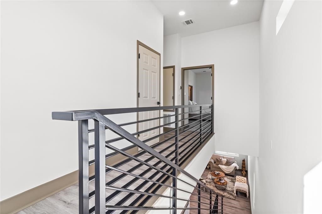 3620 Lehall Street Houston, TX 77021 - Photo 19 of 32 a view of a hallway with wooden floor and staircase