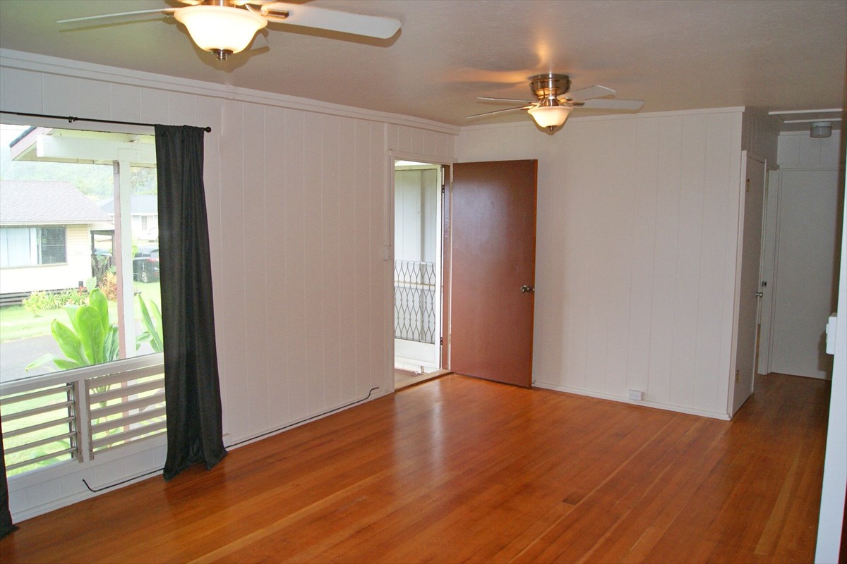 5230 Kihei Road Kapaa, HI 96746 - Photo 8 of 24 an empty room with wooden floor and windows