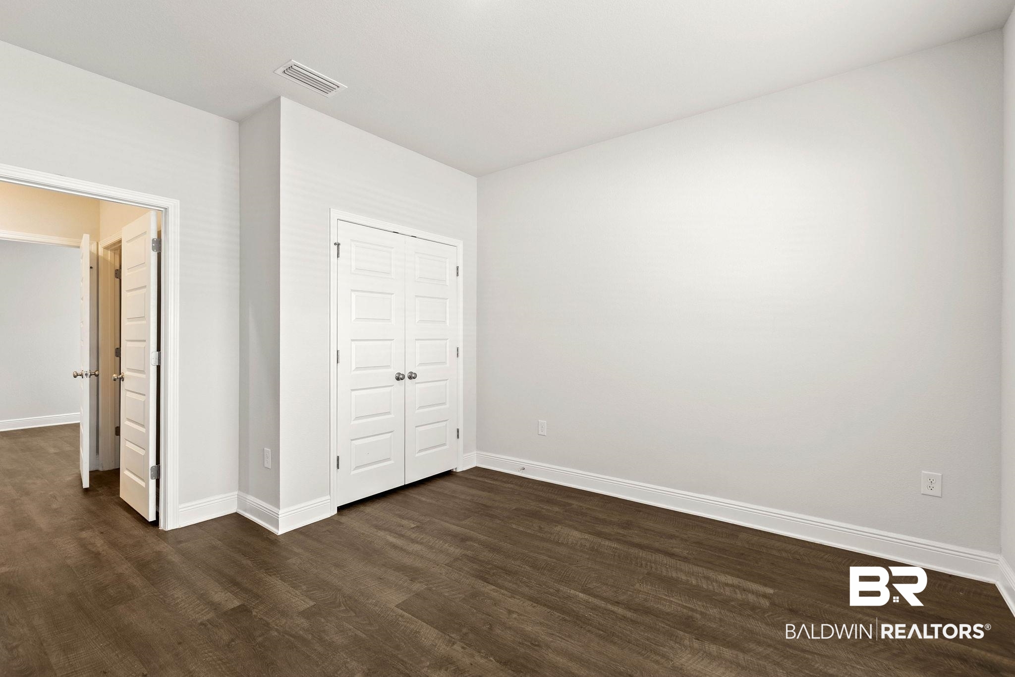 9448 Amethyst Drive Daphne, AL 36526 - Photo 32 of 61 Unfurnished bedroom with dark wood-style floors and a closet