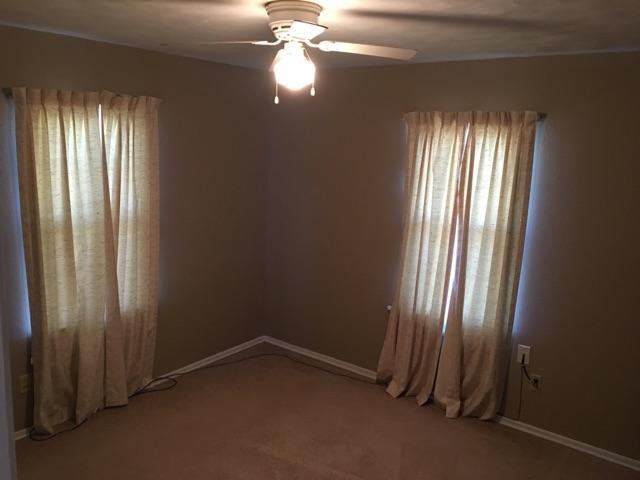 203 Southwest Nabors Ropesville, TX 79358 - Photo 6 of 10 an empty room with windows and chandelier fan