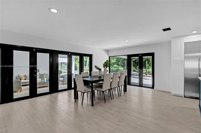 a spacious bedroom with a large bed and a potted plant
