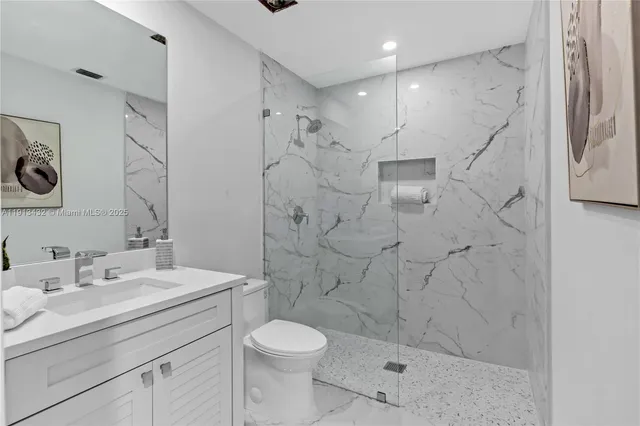 a view of yellow house with a yard and potted plants