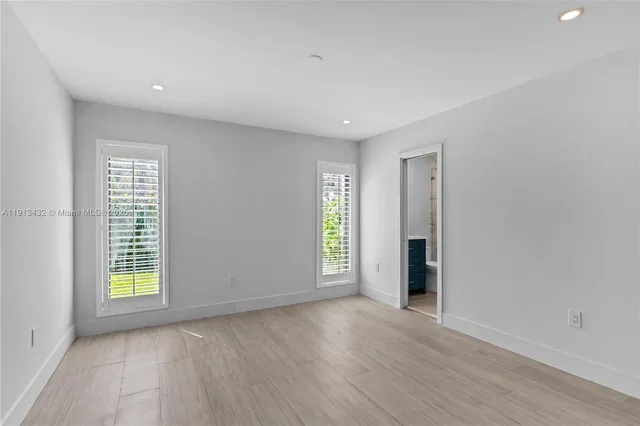 an aerial view of a house with a yard and lake view