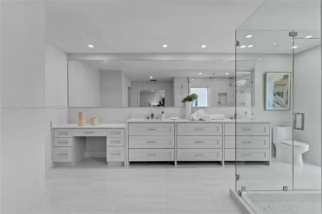 a living room with furniture a flat screen tv and a large window