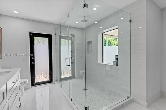 a spacious bedroom with a large bed and a large window