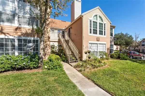 a view of a house with a small yard and plants