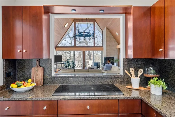 a kitchen with granite countertop a stove a sink and a granite counter top
