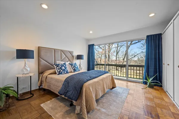 a bedroom with a bed and a large window