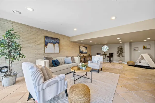 a living room with furniture and large windows