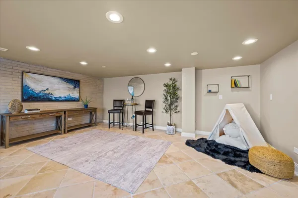 a bedroom with a large bed and ceiling fan