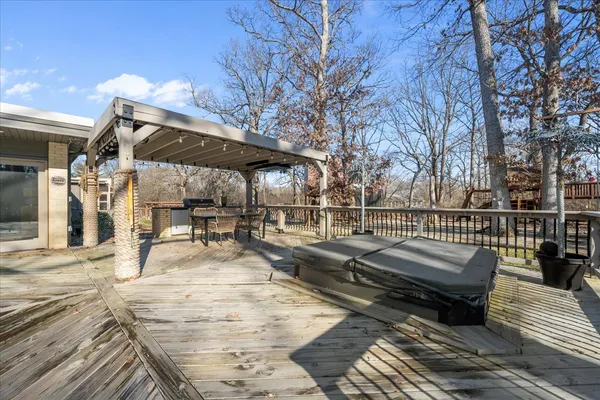 a view of a backyard with table and chairs under an umbrella