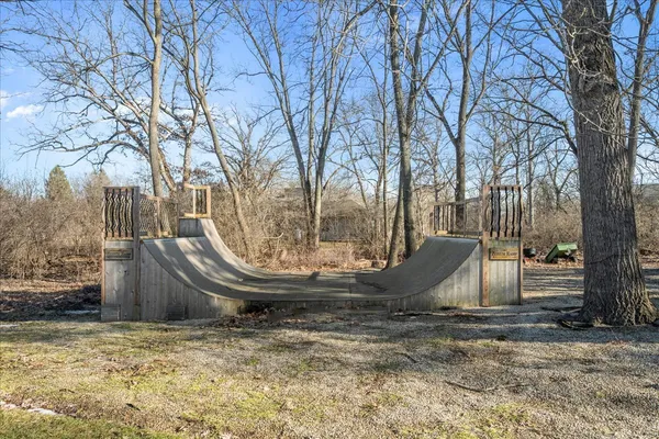a view of a chairs and table in backyard