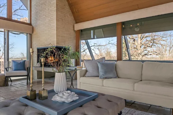 a living room with furniture a chandelier and a large window