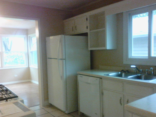 9 Crescent Road Lake Zurich, IL 60047 - Photo 3 of 14 a kitchen with a white cabinets and a refrigerator
