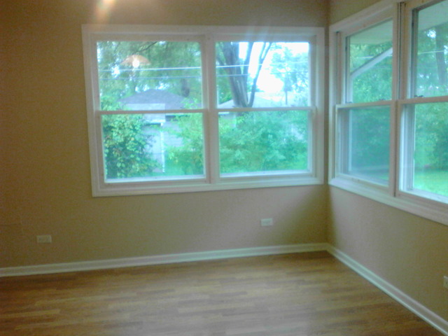 9 Crescent Road Lake Zurich, IL 60047 - Photo 10 of 14 a view of an empty room with wooden floor and a window