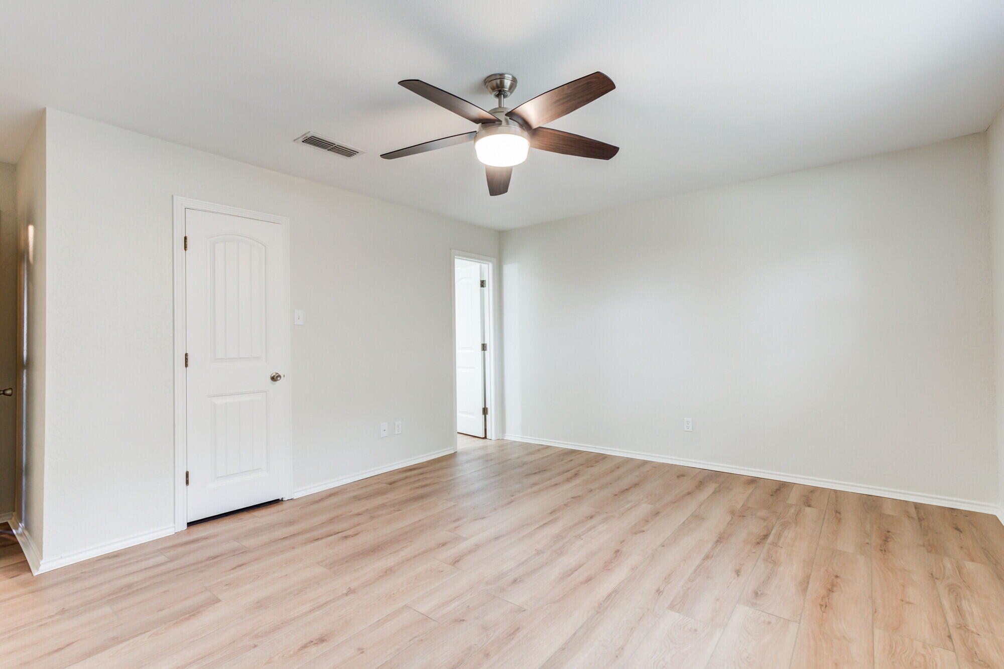 5309 77th Street Lubbock, TX 79424 - Photo 19 of 36 a view of an empty room with wooden floor