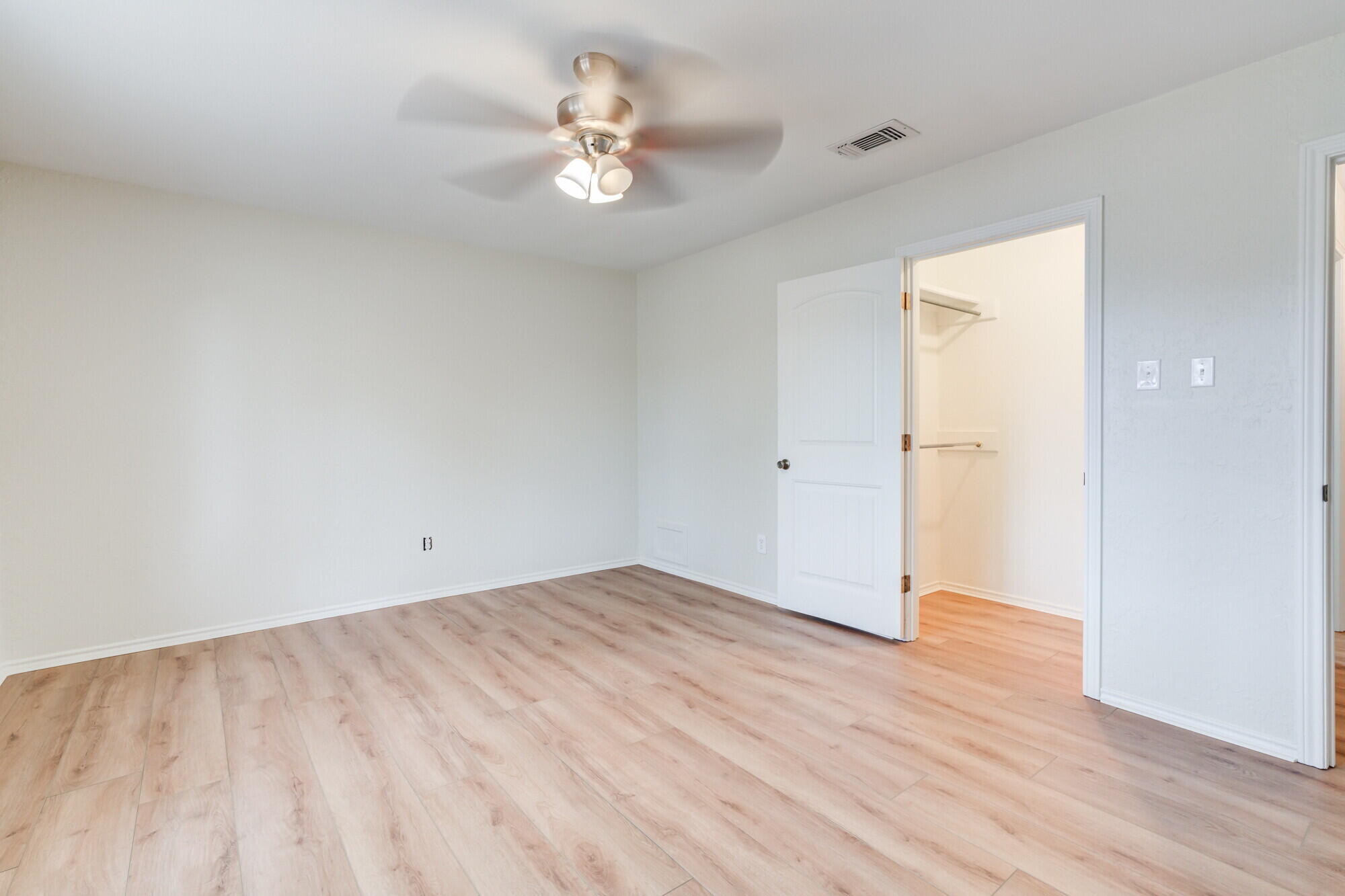 5309 77th Street Lubbock, TX 79424 - Photo 28 of 36 an empty room with wooden floor and chandelier fan