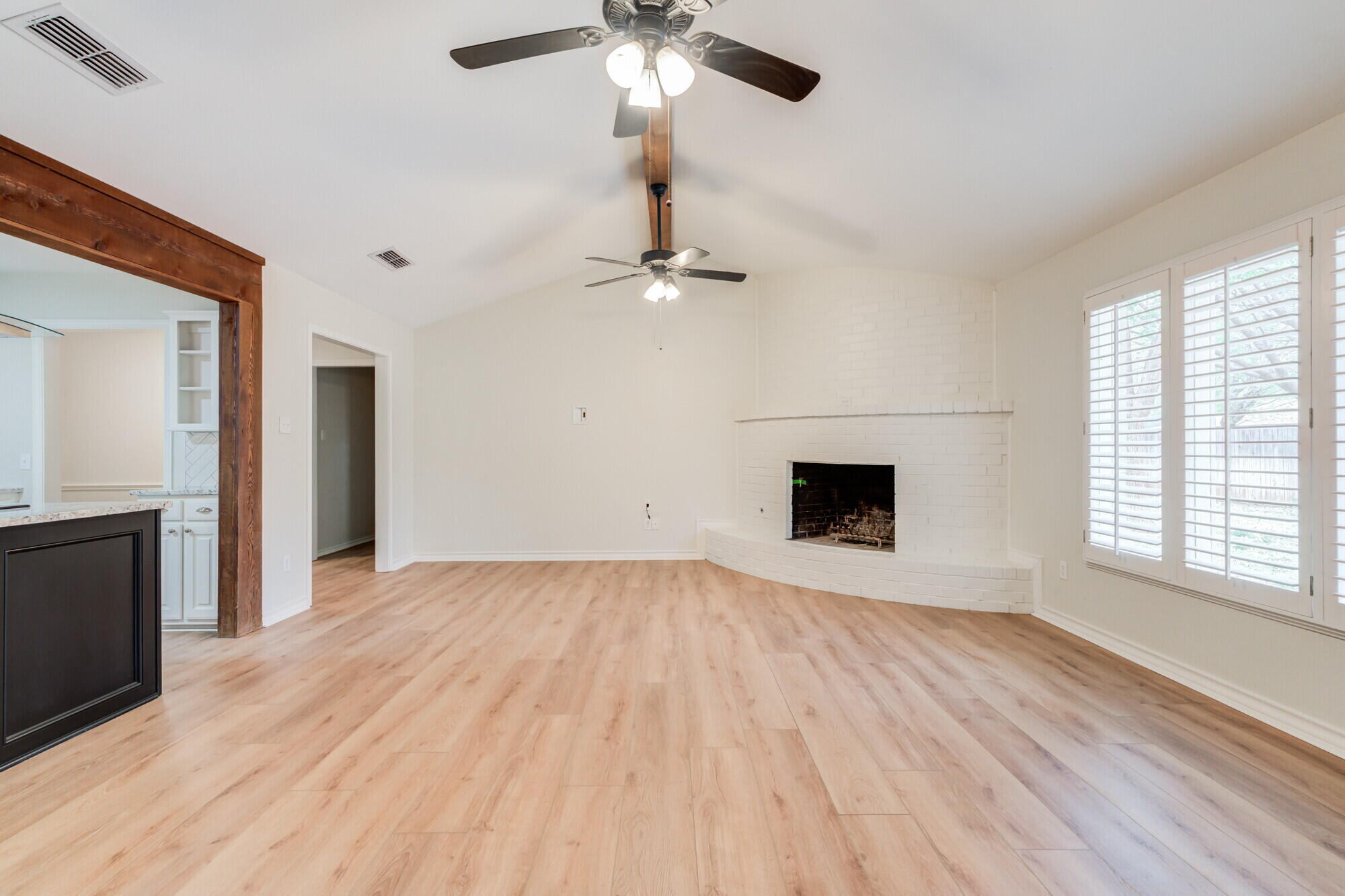 5309 77th Street Lubbock, TX 79424 - Photo 3 of 36 an empty room with wooden floor fan and windows