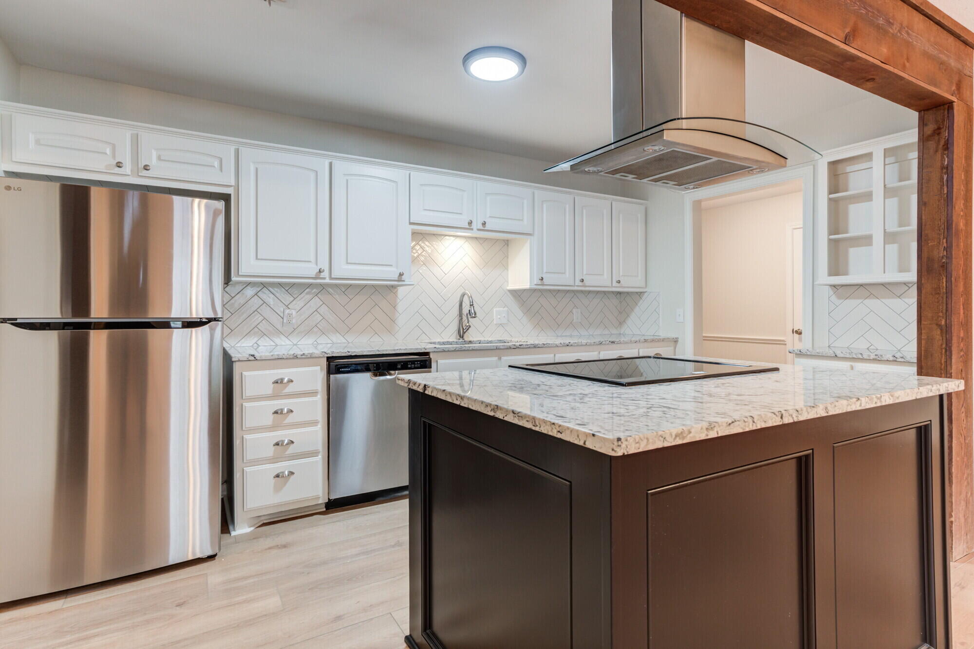 5309 77th Street Lubbock, TX 79424 - Photo 10 of 36 a kitchen with granite countertop a sink cabinets stainless steel appliances and a window
