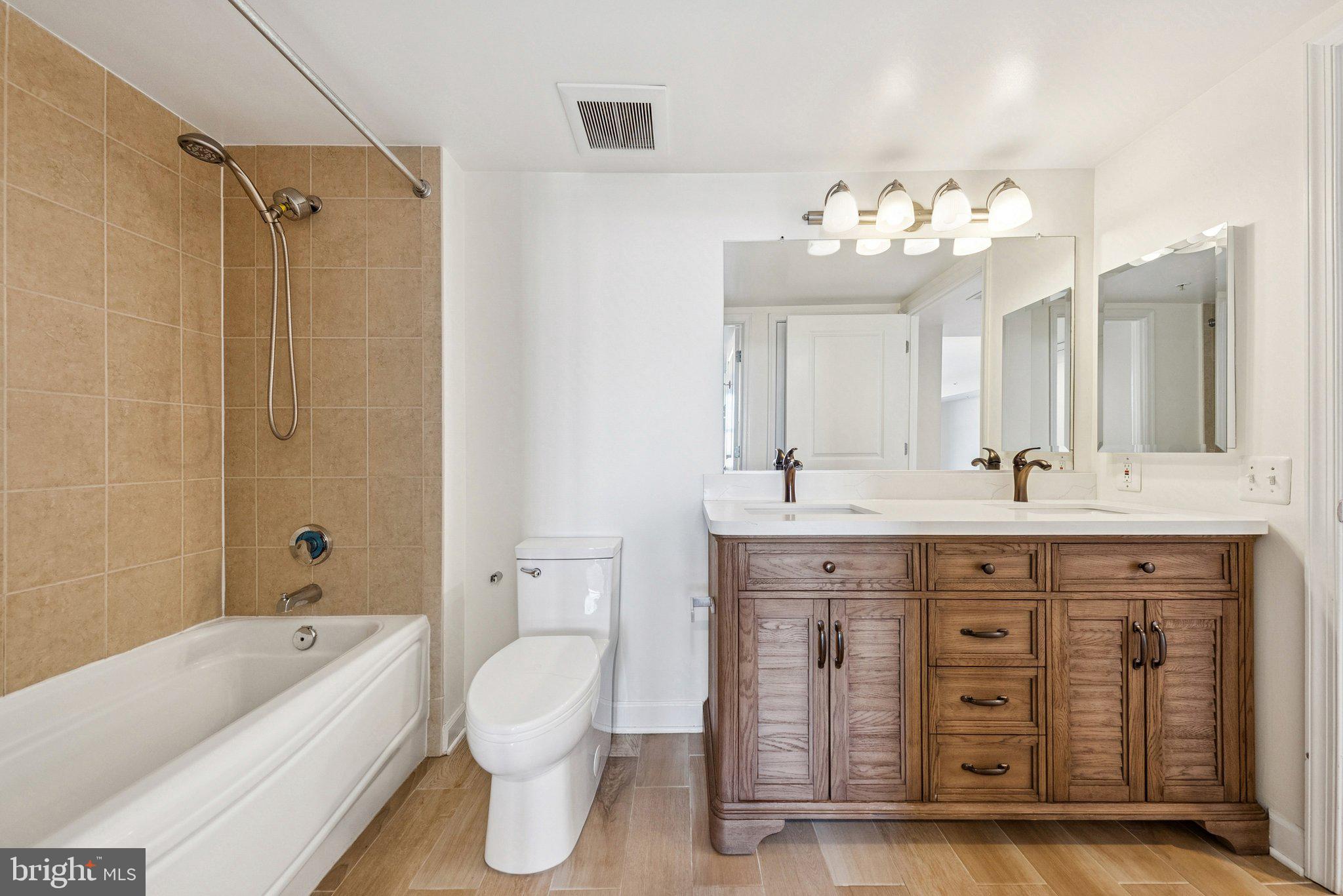 11800 Sunset Hills Road, Unit 1125 Reston, VA 20190 - Photo 17 of 24 a spacious bathroom with a double vanity sink mirror double and bathtub