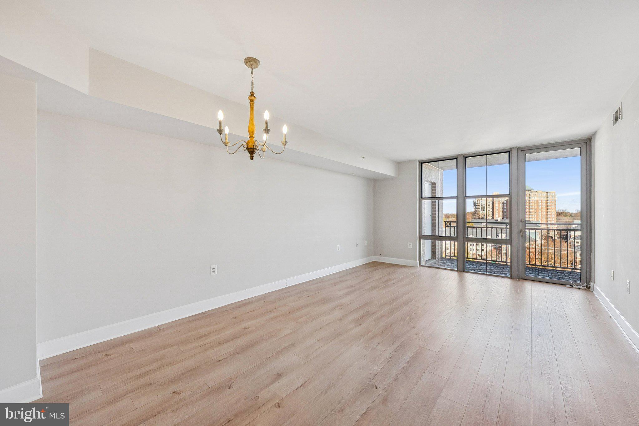 11800 Sunset Hills Road, Unit 1125 Reston, VA 20190 - Photo 2 of 24 a view of an empty room with wooden floor and a window