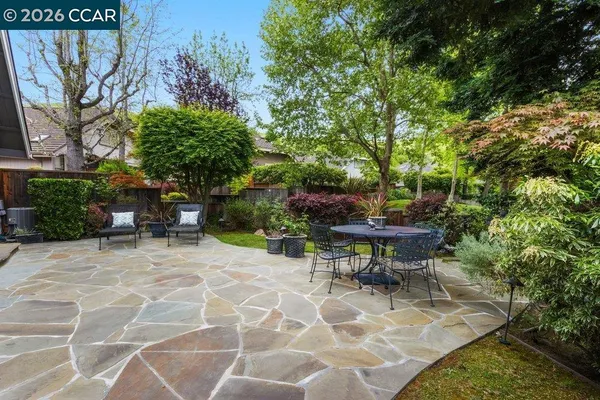 a view of a house with backyard and sitting area