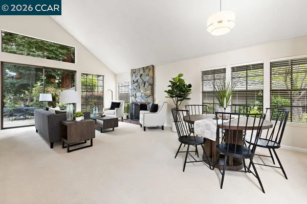 a living room with furniture and a floor to ceiling window