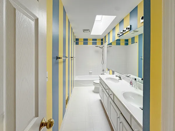 a bathroom with a tub sink and mirror