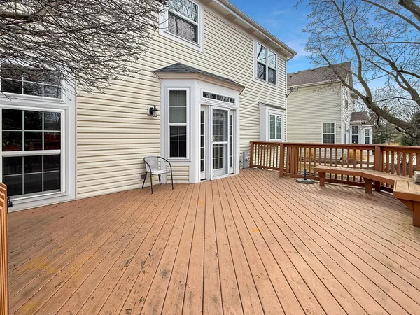 a view of a house with a wooden deck