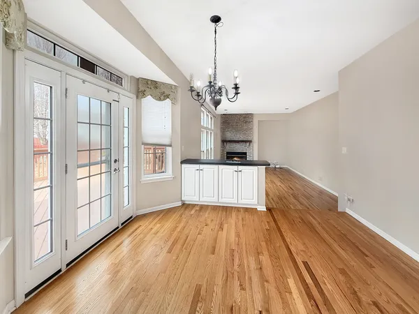 a view of a kitchen with wooden floor and electronic appliances