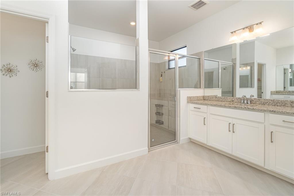 11127 Canopy Loop Fort Myers, FL 33913 - Photo 8 of 29 Bathroom featuring vanity, a shower stall, and light tile patterned floors